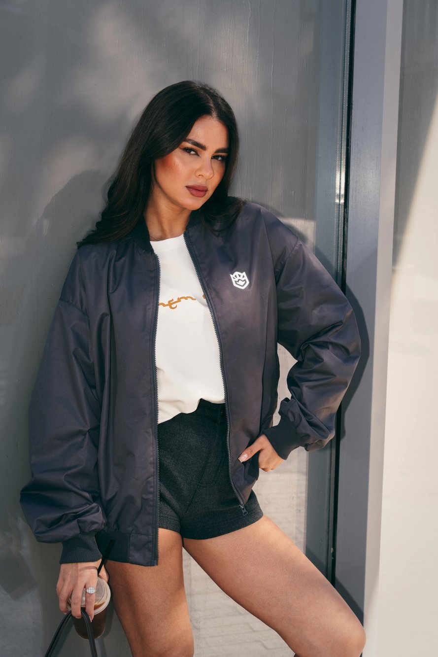Ak Bars merch — model in a bomber jacket over a club tee