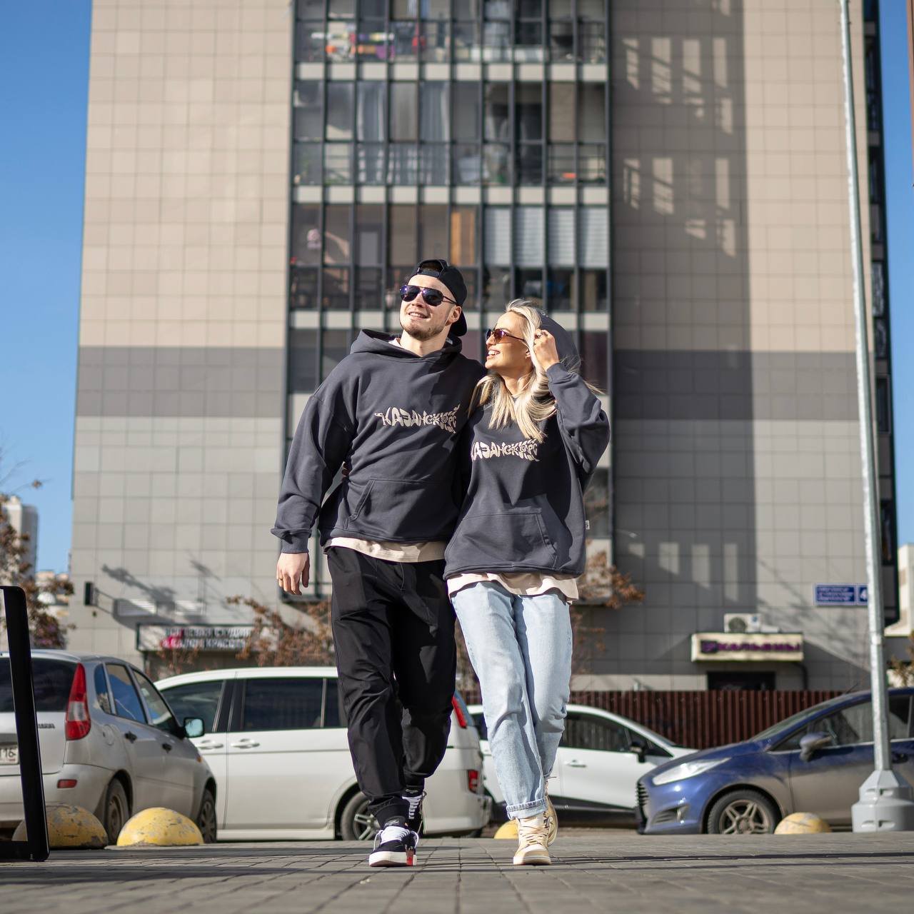 Ak Bars drop 1 — a couple walking outside in Ak Bars streetwear