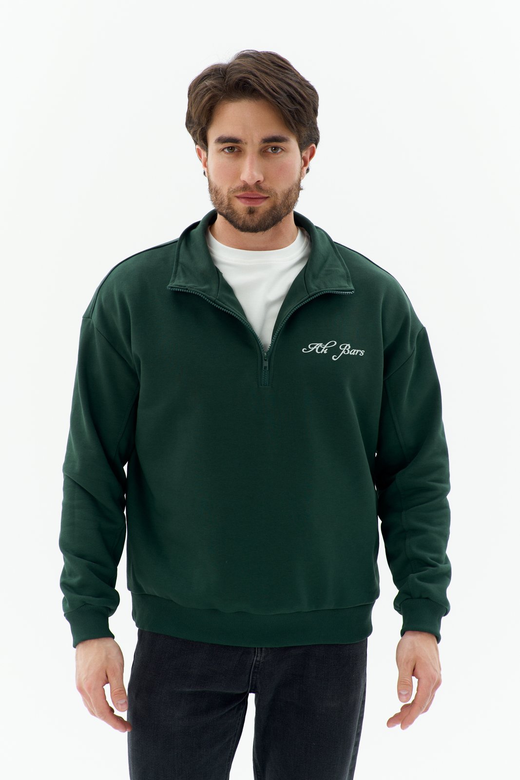 Ak Bars drop 2 — studio product shot of a man in a dark-green quarter-zip