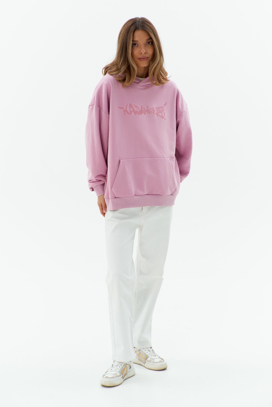 Ak Bars drop 2 — studio product shot of a woman in a pink hoodie