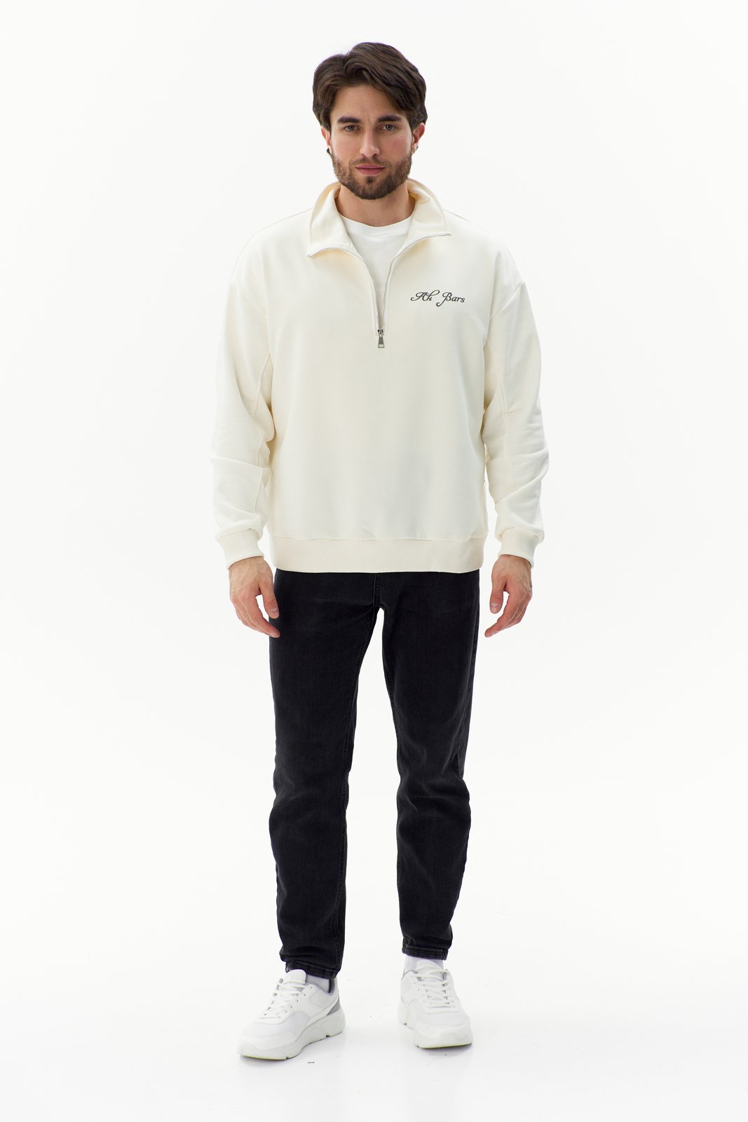 Ak Bars drop 2 — studio product shot of a man in a cream quarter-zip