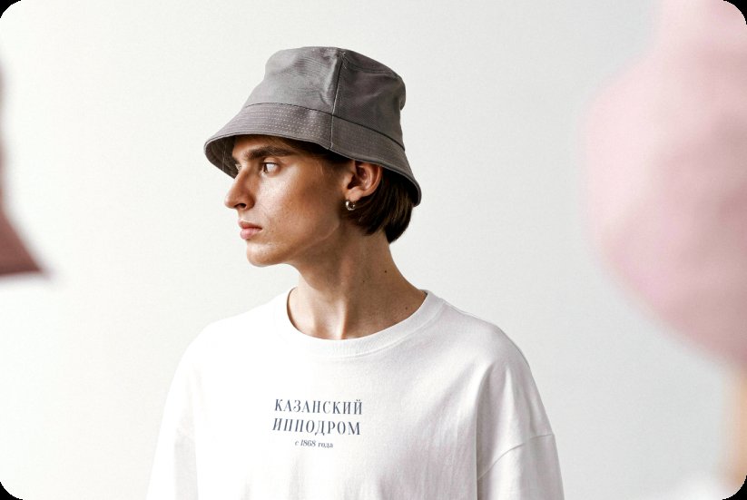 Model wearing a grey Kazan Racecourse bucket hat and a white branded long-sleeve